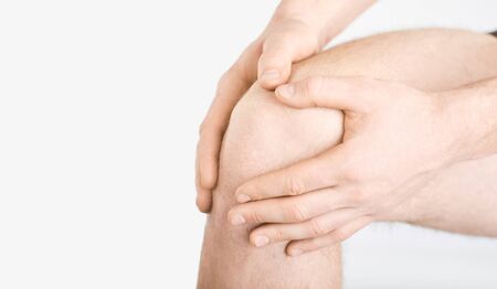 Trauma, pain, knees. Ligament rupture. Rupture of the meniscus. A man in underwear holds his knee...