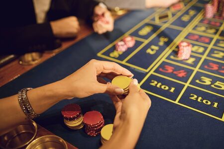People play casino poker at a table in a casino. Betting. Gambling A game. Player makes bets on...