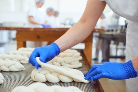 Raw baked dough lies on the table before baking in the oven at the bakery.の写真素材