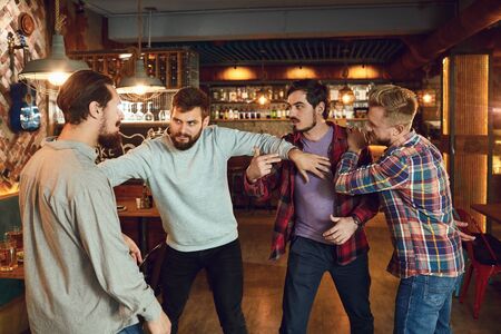 Men fight in a pub bar. Drunk people are fighting in a pub.