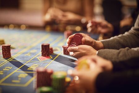 People gamblers play make bets while sitting at the roulette table in a casino.の写真素材