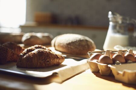 Bakery baker bread. Fresh homemade crisp bread on a table in the kitchen at the bakery.の写真素材