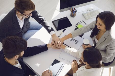 Teamwork business people joining hands at a table in the office. Business People Startup Partnership Partnership Brainstorming Marketing Team Analysis Strategy Strategy Conceptの写真素材