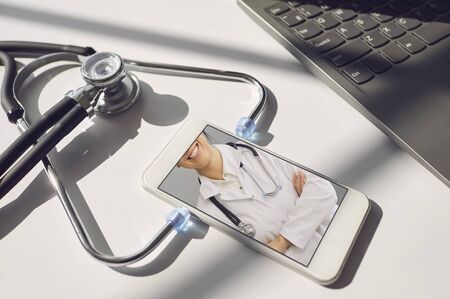 Doctor online. Online medical consultation for patients. Telemedicine. Concept video chat with a medical professional doctor therapist diagnosis analysis diagnosis of disease symptoms prescription medical insurance service using a mobile laptop tablet.の写真素材