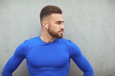 Bearded guy in sportswear on gray background. Sport lifestyle.の写真素材
