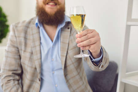 Online dating concept. Funny fat man with glass of wine having romantic talk to his girlfriend on webcam from home. Young guy speaking with his lover through internetの写真素材