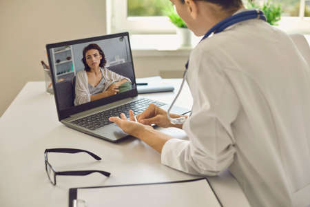 Telemedicine or telehealth concept.A young woman doctor in her office gives an online consultation....
