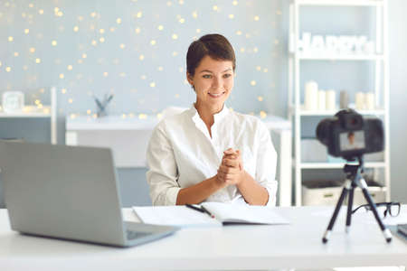 Happy female influencer and vlogger recording video for followers thanking them for support....