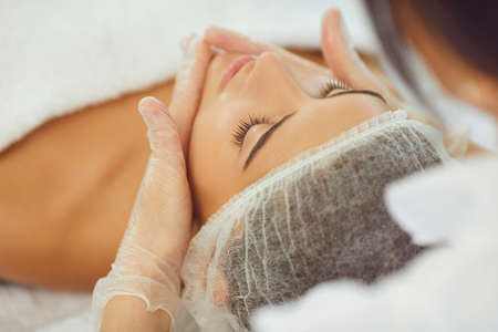 Woman face skin massage treatment in cosmetic spa beauty salon.の写真素材