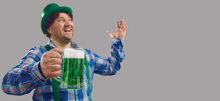 Young guy celebrating St Patricks Day and enjoying good alcohol at bar hopping parties. Happy Irish...