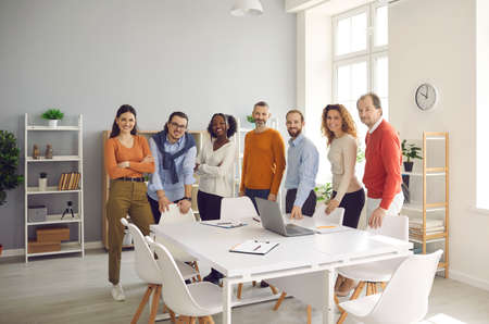 Dream team reaching success together. Group portrait of happy smiling confident diverse business...