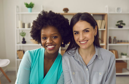 Friendly african american and caucasian coworker or students friends headshot portrait in office. Multiracial friendship, good quality racial diversity equality, equal opportunity in the workplaceの写真素材