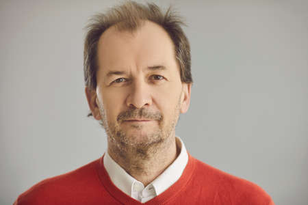 Happy balding senior European man with friendly face expression looking at camera. Head shot...
