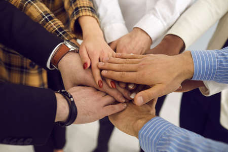 Business people worker corporate support meeting hands or volunteer trust joined palms together closeup shot top viewの写真素材
