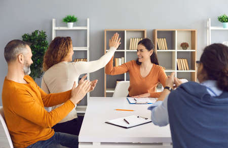 Happy professional business teams making successful deal. Group leaders celebrating success and...