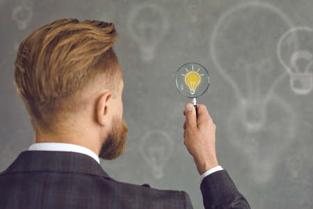 Creative entrepreneur or executive manager searches and finds the best business idea. Back view of...