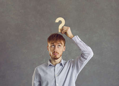 Puzzled young beginner businessman is looking for answers about the development of his business....
