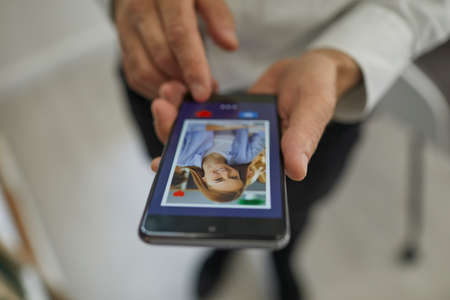 Online dating concept. Closeup man pressing red heart button and giving a like to attractive young...