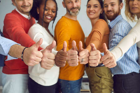 Group of different senior and young people giving thumbs up. Dream team of smiling friends, colleagues or business partners doing like gesture, hands closeup. Satisfaction, successful teamwork conceptの写真素材