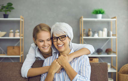 Family portrait of happy beautiful senior mother and loving grown-up daughter. Mature grandma...