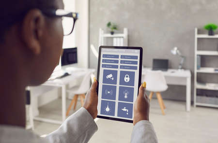 People and technology: Black lady holding digital touchscreen tablet and using app interface with...