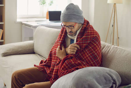 Its winter and its cold in the house. Man having problems with central heating in wintertime....