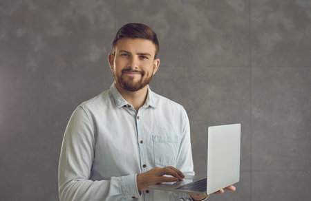 Confident smiling business expert working with joy. Millennial caucasian handsome man in shirt...