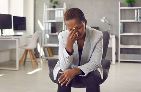 Exhausted and frustrated woman is working on difficult business task and has bad conversation. Tired...