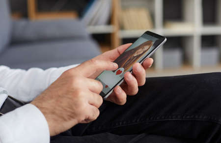 Old man in search of love partner using online dating website or mobile phone app. Senior male...