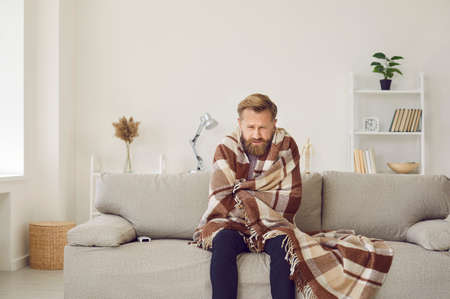 Its cold at home in wintertime. Man freezing in his house in winter because of broken thermostat....