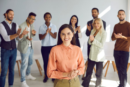 Portrait of happy business professional and team leader. Beautiful young woman standing in office...