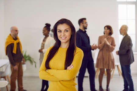 Portrait of successful young businesswoman pose in office show leadership and confidence. Profile picture of smiling woman employee or worker forefront at workplace. Business leader or ceo.の写真素材
