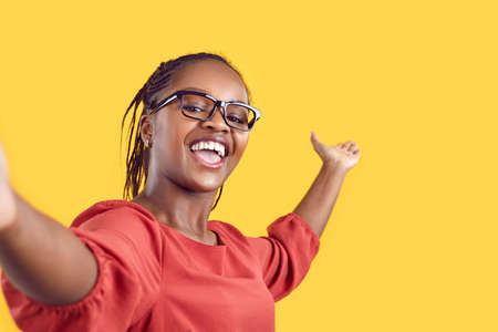 Happy cheerful confident black woman takes selfie, films tourist sightseeing view travel vlog or new...