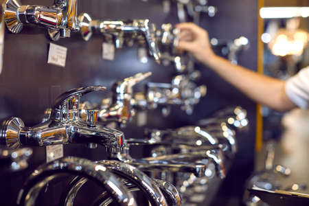 Wide range of water taps at a modern mall. Closeup shot of new shiny chrome plated faucets at a...