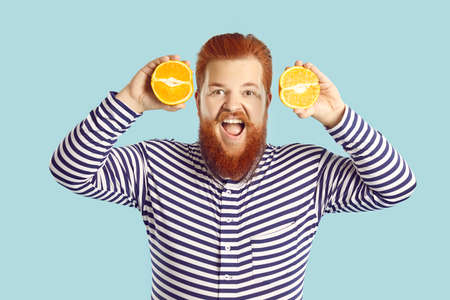 Fat man in striped pajamas or swimsuit who likes eating fresh fruit rich in vitamins and...