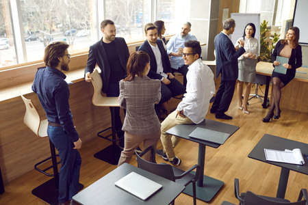 Nice talk. Friendly diverse employees or office workers communicating, talking, joking and sharing...