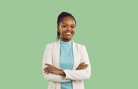 Studio portrait of black businesswoman with toothy smile. Confident good looking young woman with...