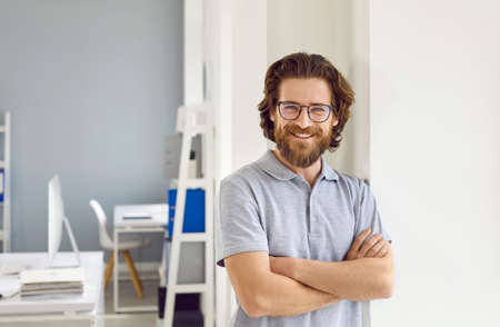 Portrait in office of successful, smart and cheerful businessman, manager or entrepreneur. Happy...