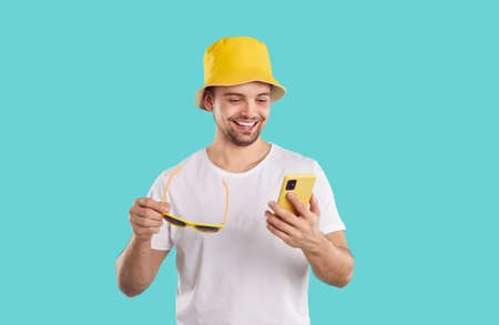 Cheerful joyful guy with mobile phone uses mobile applications and communicates on social networks....
