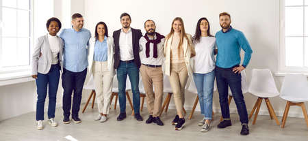 Portrait of positive progressive business team posing in office or conference room. Multiracial...