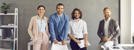 Group portrait of confident and successful colleagues or company executives in the office. Friendly...