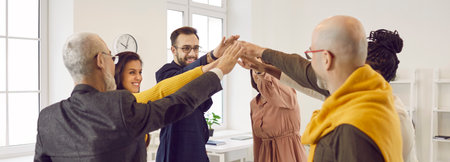 Working synergy. Business people who are inspired by fruitful cooperation join hands in unity and...