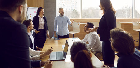Business team during morning briefing in office discussing ideas and exchanging interesting ideas....