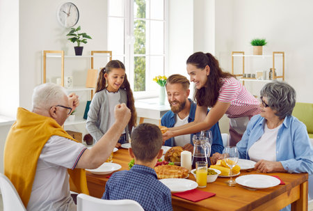 Family meal. Joyful family enjoying dinner at home. Happy family with little children sitting around...