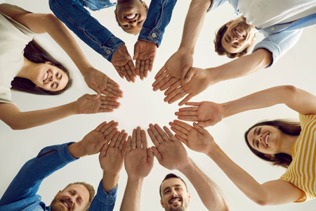 Team of happy diverse people joining hands to show concept of teamwork. Group of cheerful...