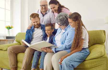 Happy big multigenerational family keep good memories of the past. Cheerful friendly smiling multi...