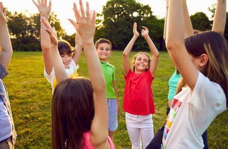 Children having fun in the park. Happy kids playing all together. Group of cheerful, excited friends...