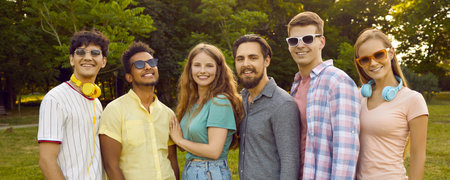 Young happy men and women millennials posing with smile for group portrait after walk with friends...