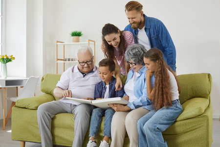 Family looks at photo album together and remembers stories from past during reunion of relatives....