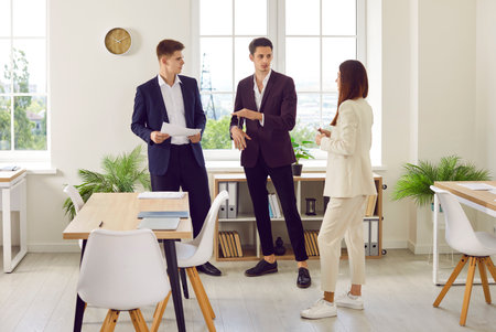 Business team meeting in the office. Group of young people working together. Several corporate...